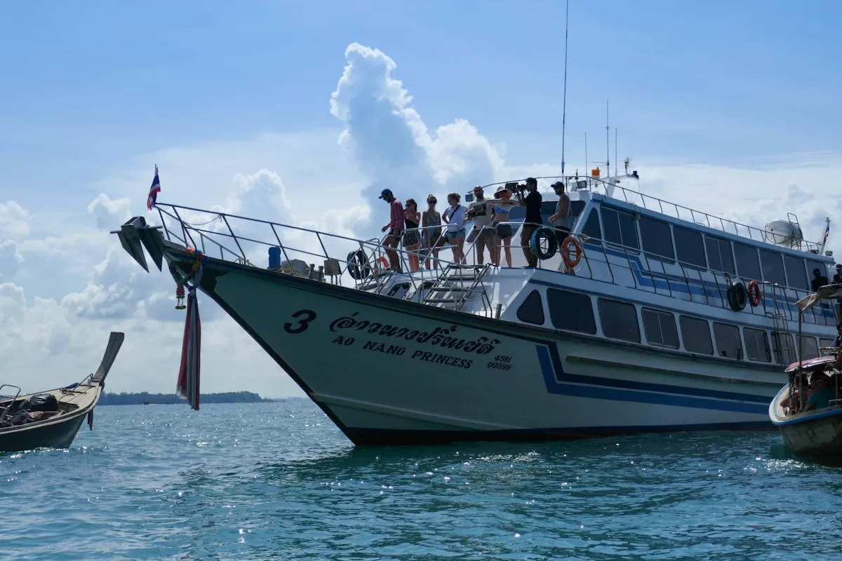 People riding on a yacht on the sea during daytime